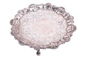 A George III silver waiter, by Richard Rugg, London 1764, of circular form, with raised border