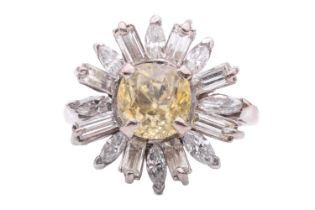 A yellow sapphire and diamond daisy cluster ring, set to the centre with a cushion shape yellow