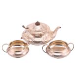 A three-piece silver tea set; circular with tongue and dart band to bellies; leaf-capped 'c'