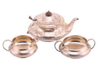 A three-piece silver tea set; circular with tongue and dart band to bellies; leaf-capped 'c'