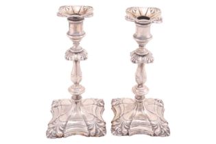 A pair of George III style candlesticks, Sheffield 1926, with banded sconces, knopped stem on square