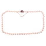 A single row graduated cultured pearl necklace with a spinel and diamond cluster clasp, the pearls
