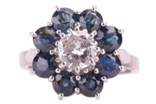 A diamond and sapphire flowerhead cluster ring, centred with a round brilliant-cut diamond of 6.2