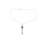 An opal and diamond pendant set with a yellow-brown fire opal suspending a floral motif set with