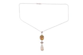 An opal and diamond pendant set with a yellow-brown fire opal suspending a floral motif set with