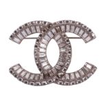 Chanel - an interlocking CC logo brooch encrusted with baguette rhinestones, signed A18V, 5.2 cm