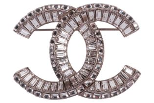 Chanel - an interlocking CC logo brooch encrusted with baguette rhinestones, signed A18V, 5.2 cm