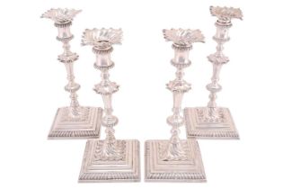 A matched set of four George III cast silver candlesticks by Ebenezer Coker; tapering knopped