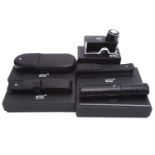 A collection of boxed Montblanc items; including two leather pouches, a three-pen leather pouch, a