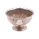 An Edwardian silver rose bowl of round spirally fluted form decorated with a flower-bordered