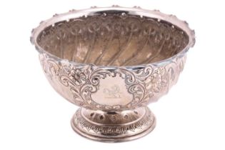 An Edwardian silver rose bowl of round spirally fluted form decorated with a flower-bordered