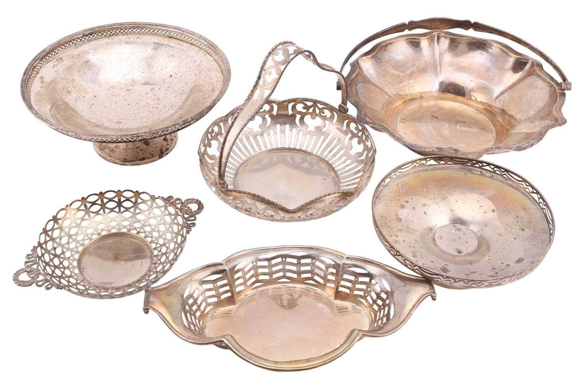 A group of five silver dishes comprising, a shallow pierced two-handled bon bon dish, a cake