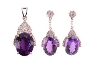 An amethyst and diamond pendant and earrings en-suite; the pendant consists of a large oval-cut
