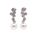 Mikimoto. A pair of Mikimoto pearl and diamond pendant earrings; comprising a drop of five