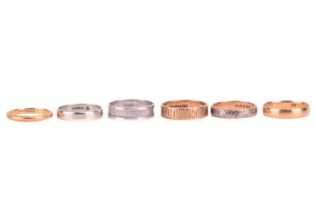 A collection of six gold wedding bands; including a 22ct gold knife-edged ring with olive leaf