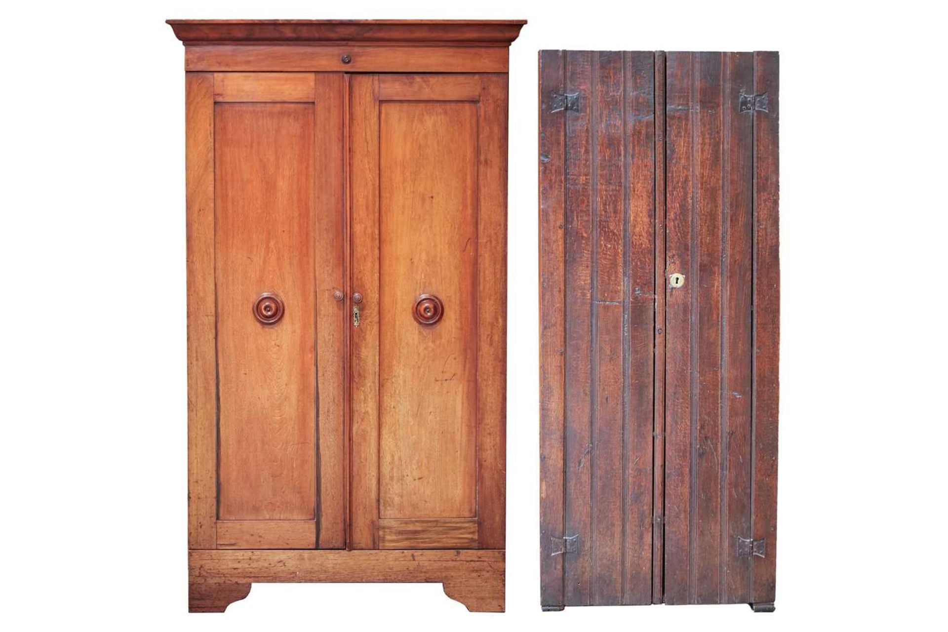 A Victorian mahogany twin door cupboard, the cavetto moulded cornice with a single roundel applied