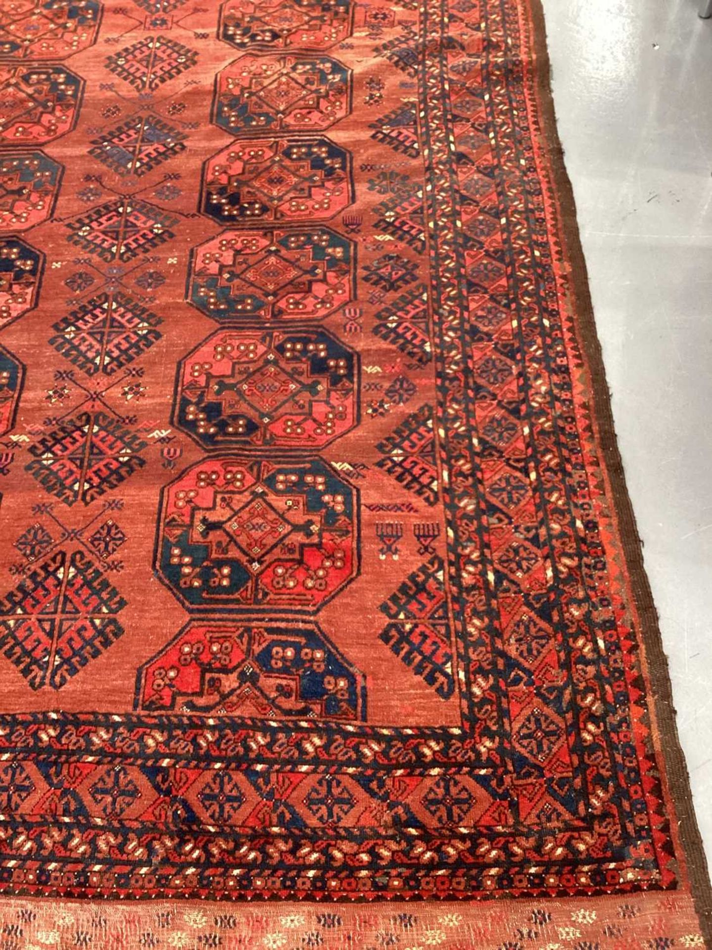 A large antique "Old country house" red ground Afghan carpet, with three rows of elephant foot - Image 17 of 28