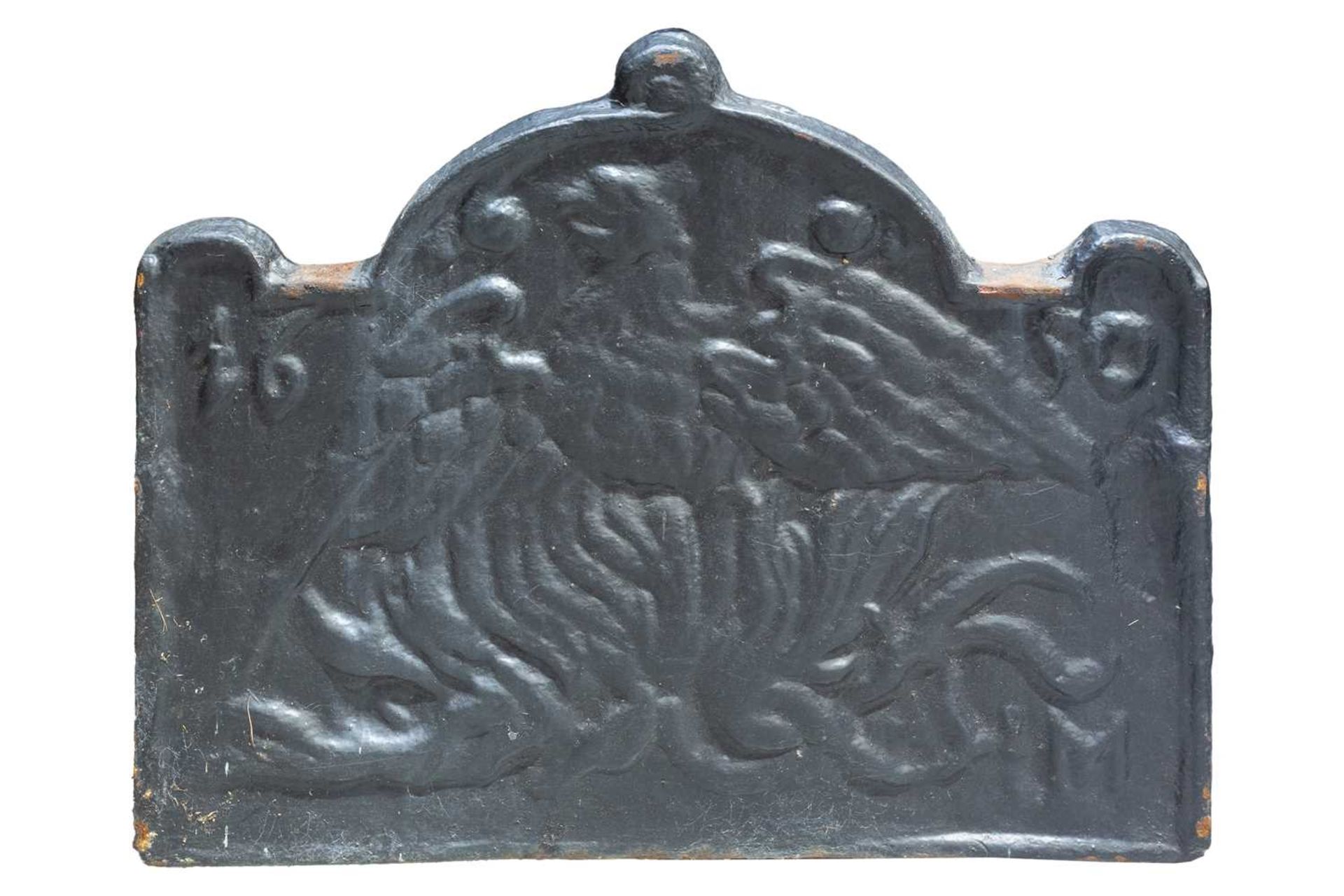 A 17th century style cast iron fire back, the shaped top over a relief decorated panel depicting