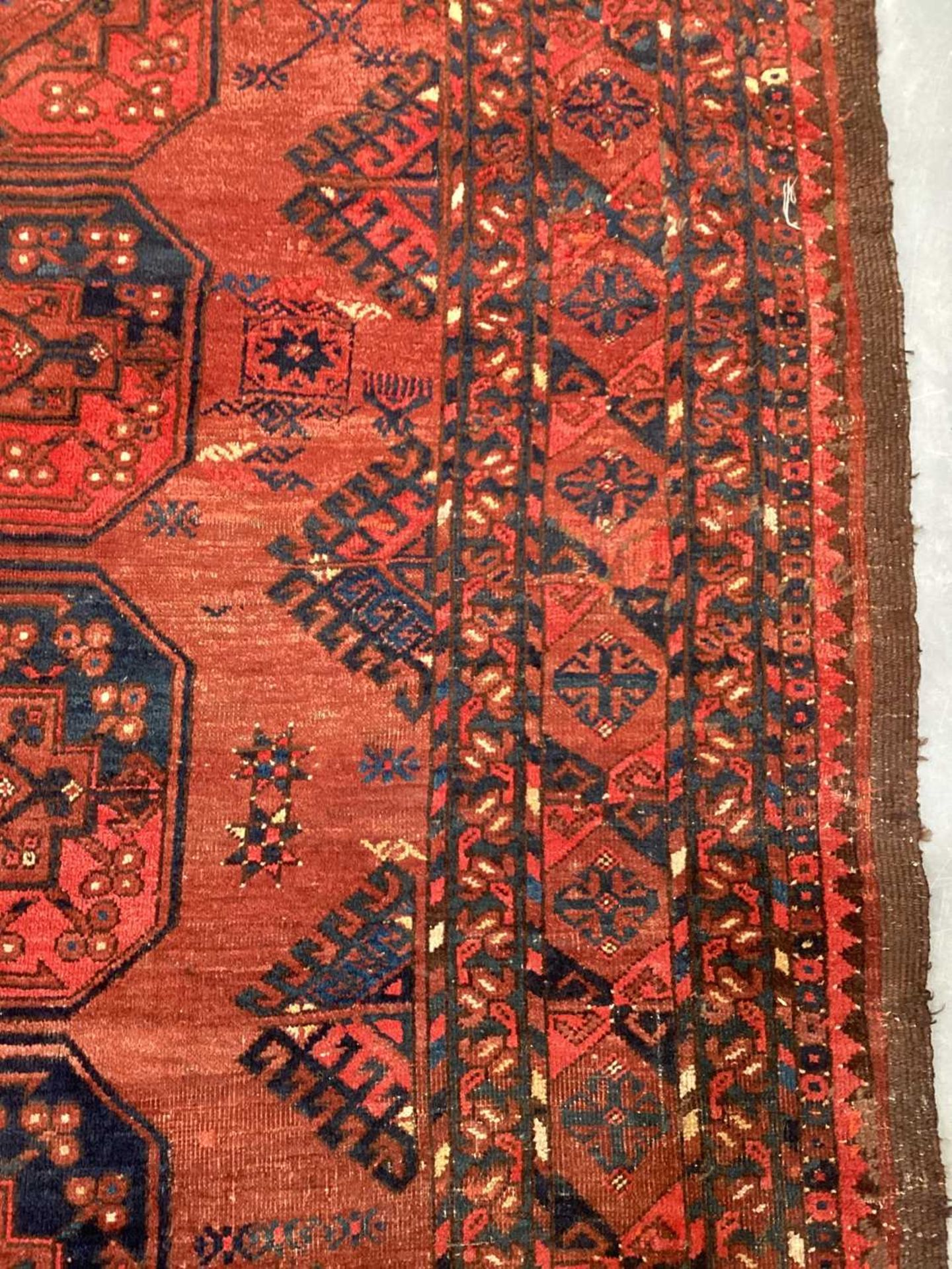 A large antique "Old country house" red ground Afghan carpet, with three rows of elephant foot - Image 20 of 28