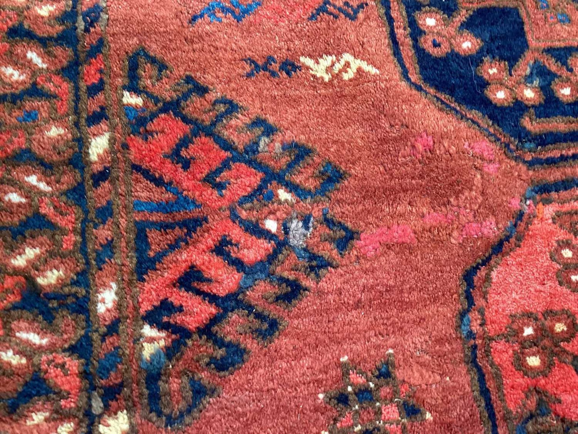A large antique "Old country house" red ground Afghan carpet, with three rows of elephant foot - Image 9 of 28