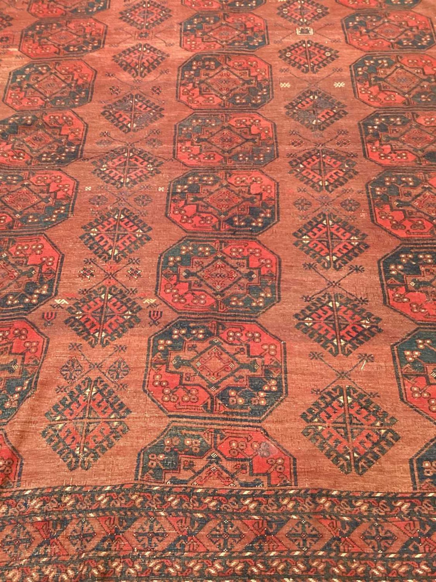 A large antique "Old country house" red ground Afghan carpet, with three rows of elephant foot - Image 28 of 28