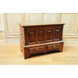 An 18th century Welsh coffer bach, the hinged top above a panel front and two short drawers, 48 cm