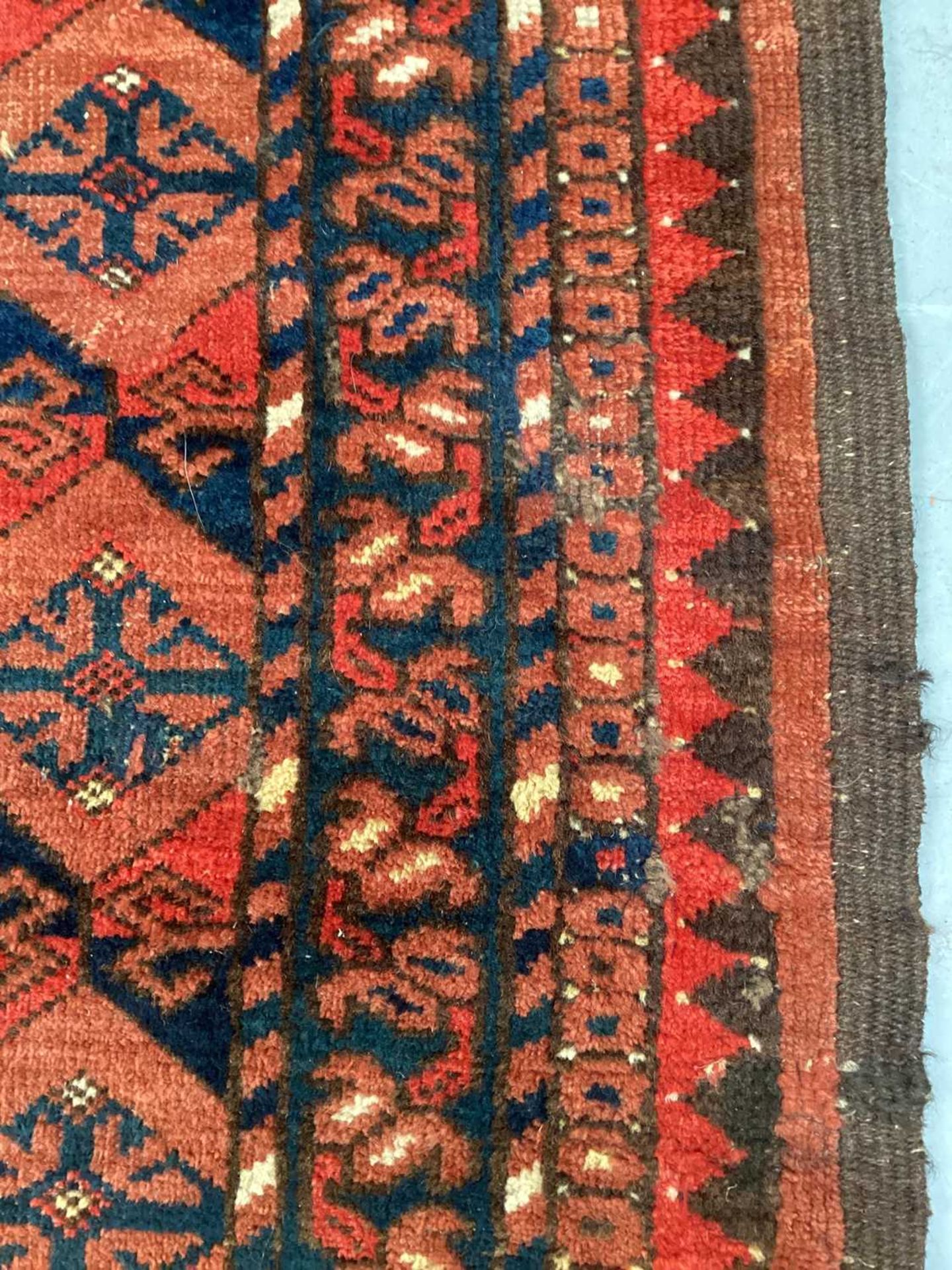 A large antique "Old country house" red ground Afghan carpet, with three rows of elephant foot - Image 12 of 28