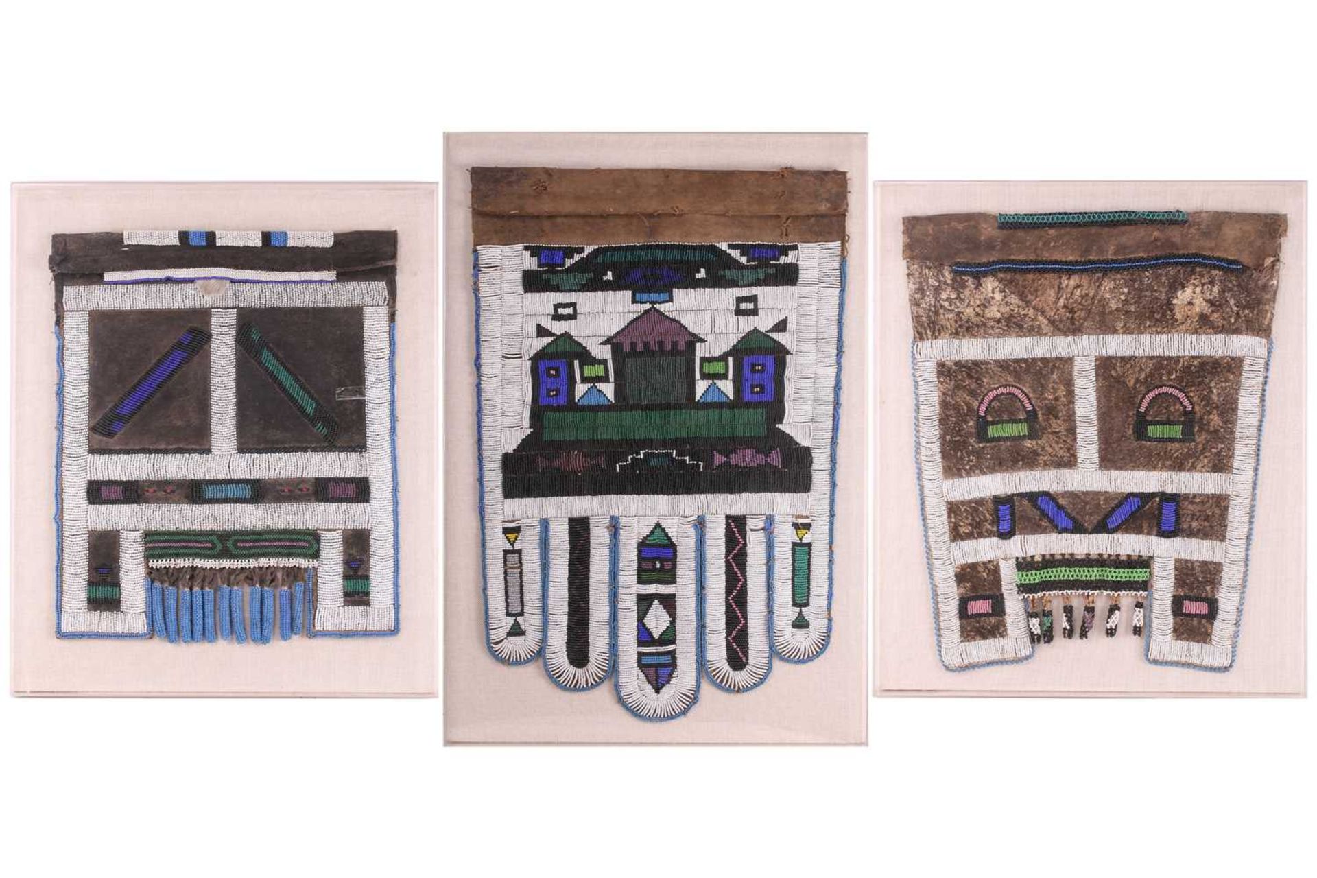 Three Ndebele tribal beadwork panels attached to a canvas and encased in a perspex-boxed frame,