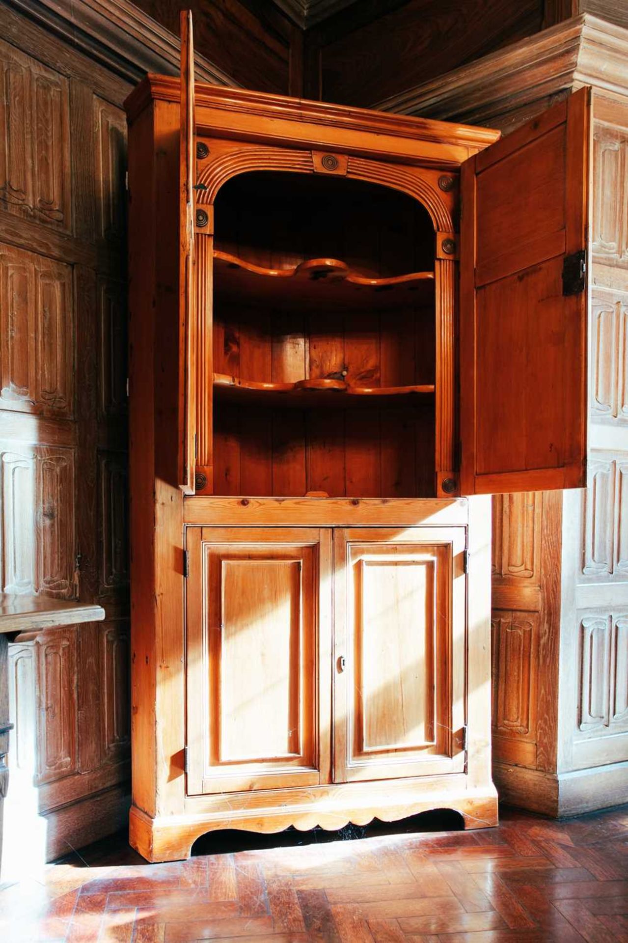 An early 19th century pine corner cupboard, with pair of panelled doors above another similar - Image 2 of 2