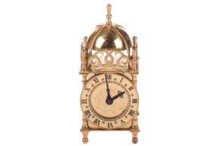 A boxed "Mid Century Vintage" Smiths electric (240v) miniature brass lantern clock. 8 cm wide x 18