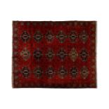 A large dark red ground Turkomen-style carpet, 20th century with cruciform guls within geometric