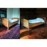 A pair of French fruitwood single sleigh beds, 19th century and later adaptations with panelled ends