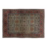 An antique ivory ground Kerman rug with an allover floral design within multiple borders 202 x 137cm