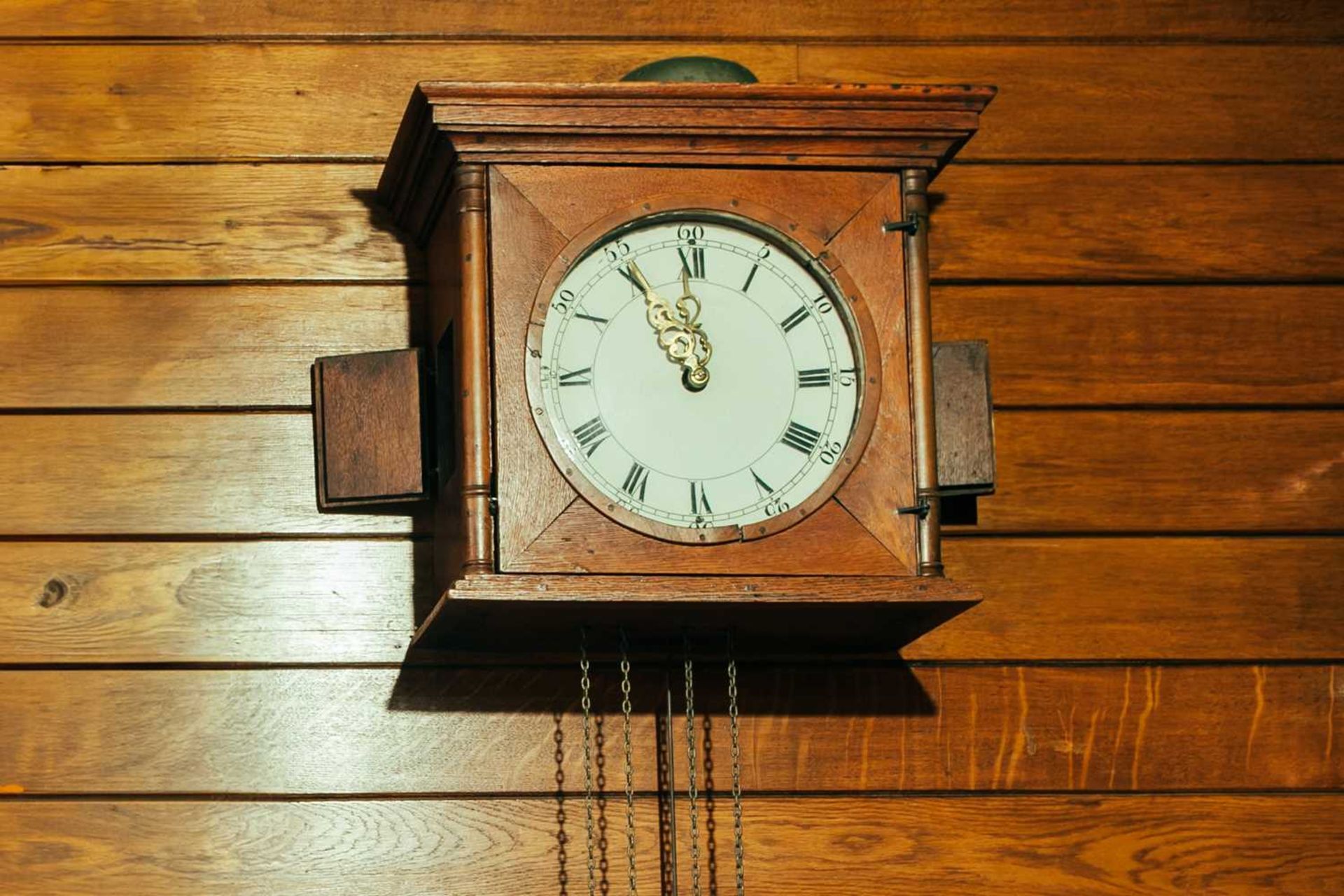 An Austrian 19th-century 30-hour wall clock with a simple hood and enamel Roman convex dial, 42 cm