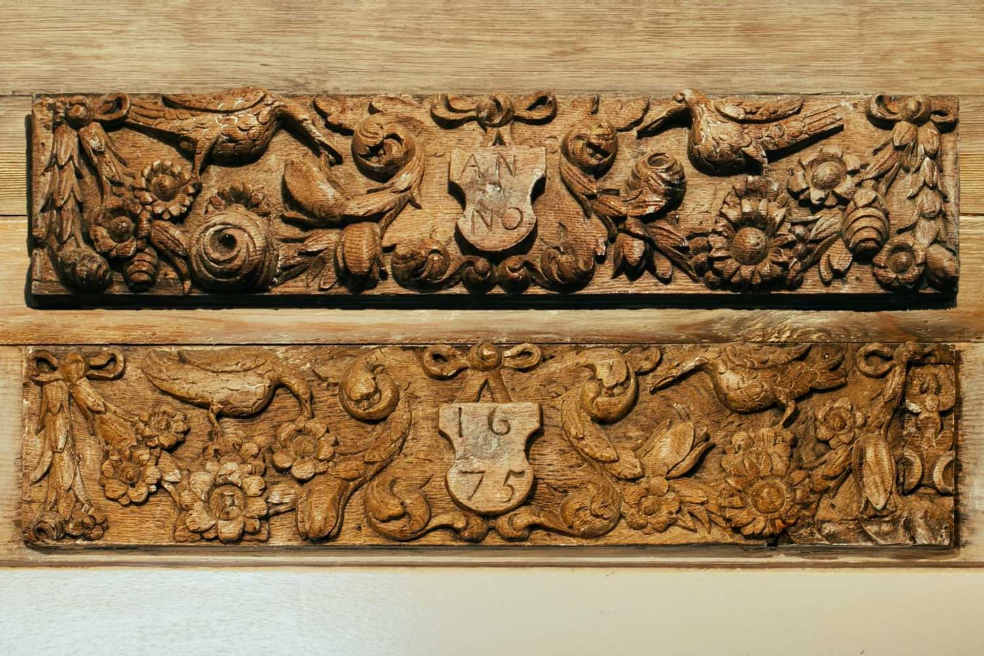 A pair of 17th century oak carved panels, one dated '1675', 13 cm x 61 cm Provenance: The contents