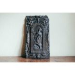 A 17th century oak carved panel, depicting a maiden within an arch, 40 cm x 22 cm. Provenance: The