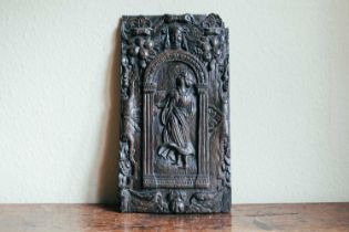 A 17th century oak carved panel, depicting a maiden within an arch, 40 cm x 22 cm. Provenance: The