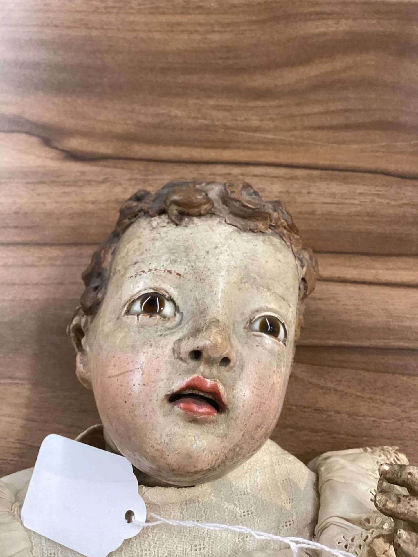 An 18th-century Spanish carved and polychromed wood figure of a cherub, with inset glass eyes, and - Image 7 of 9