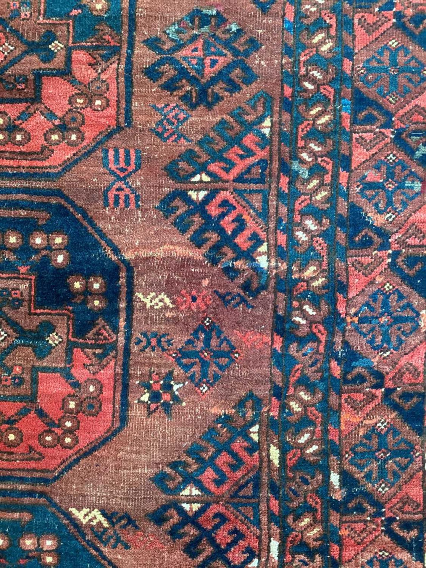 A large antique "Old country house" red ground Afghan carpet, with three rows of elephant foot - Image 19 of 28