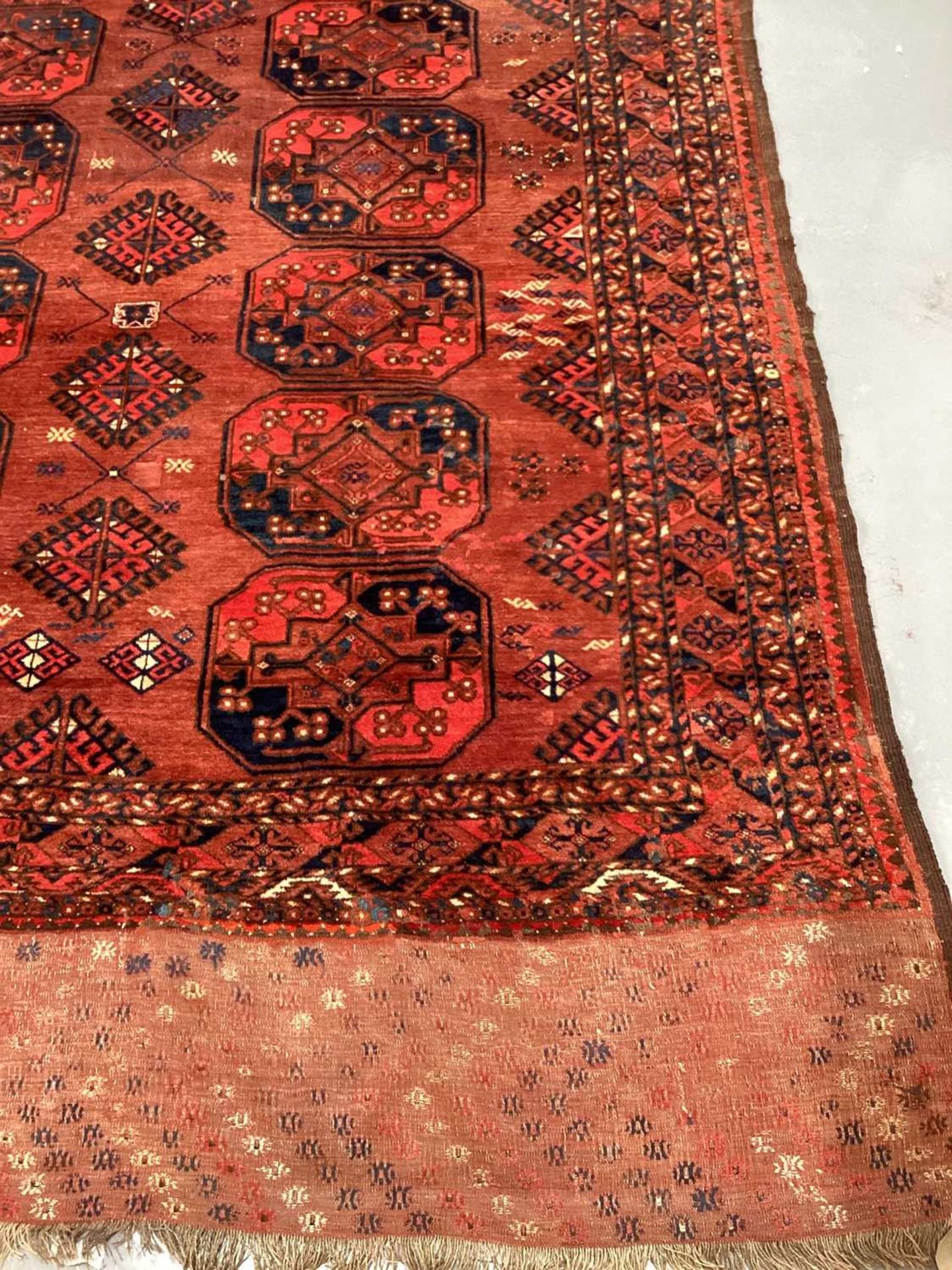 A large antique "Old country house" red ground Afghan carpet, with three rows of elephant foot - Image 8 of 28