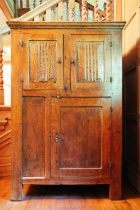 A 19th-century French oak two-door cupboard, the moulded cornice above a panelled door over a