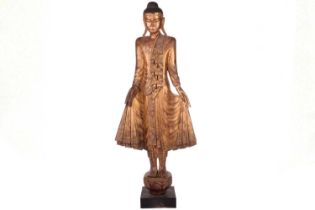 A Burmese carved and gilt wood standing Buddha in varada mudra, 19th century, set with jewels and