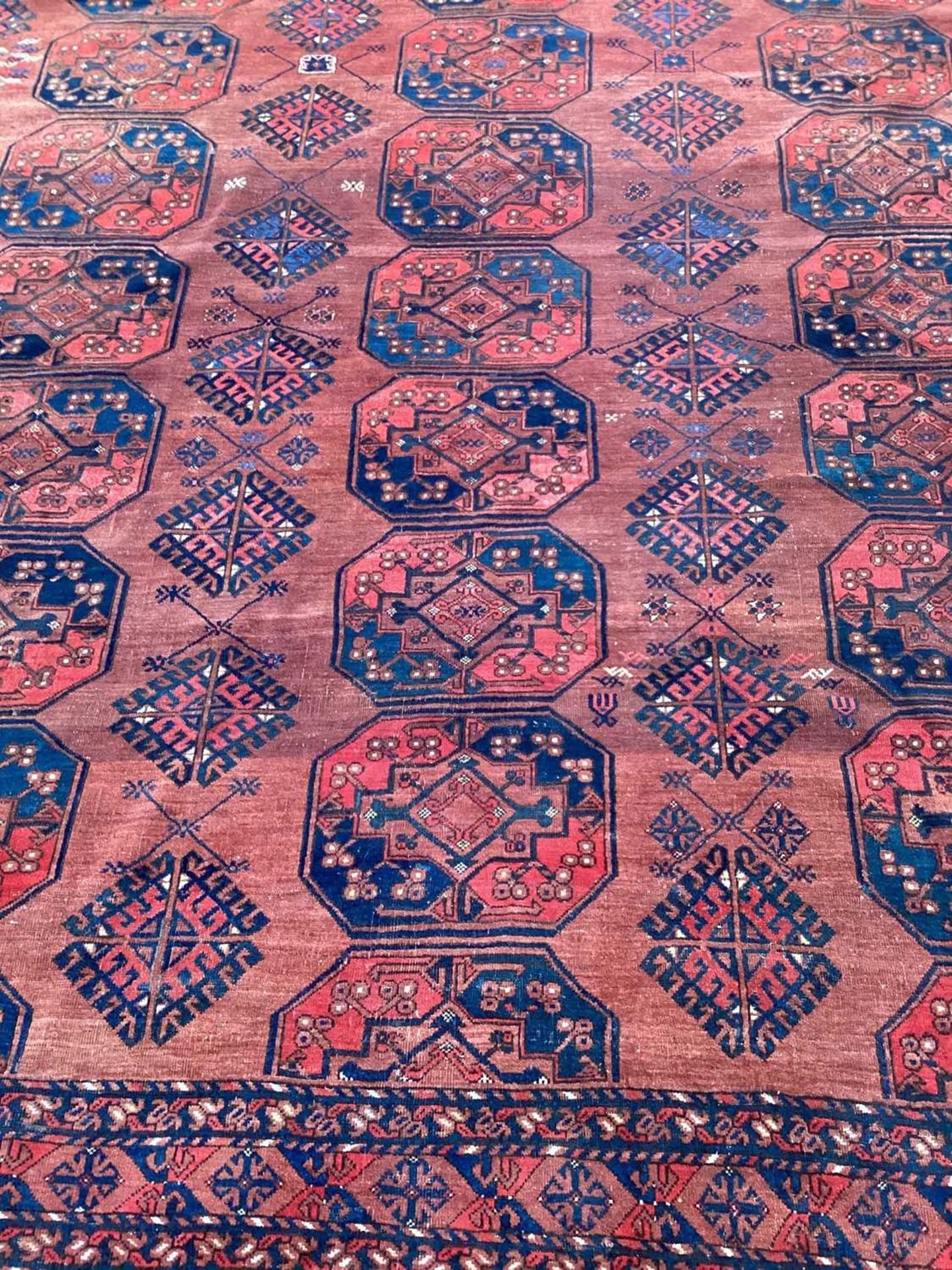 A large antique "Old country house" red ground Afghan carpet, with three rows of elephant foot - Image 16 of 28