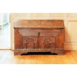 A 17th-century Continental oak coffer, with dentil moulding above two carved arcade facade on