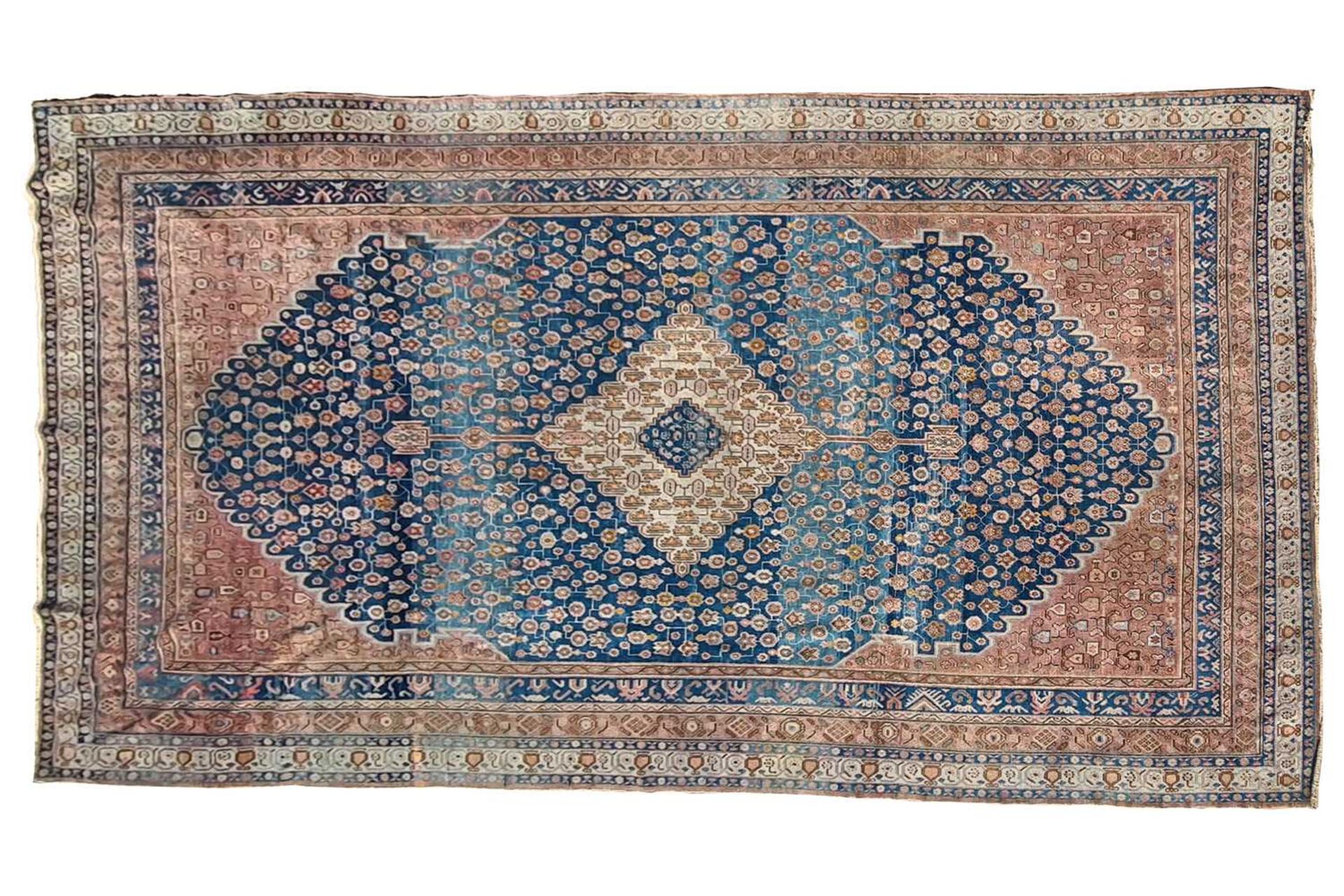 A large blue ground "old country house" Fereghan carpet with a central diamond on a field of