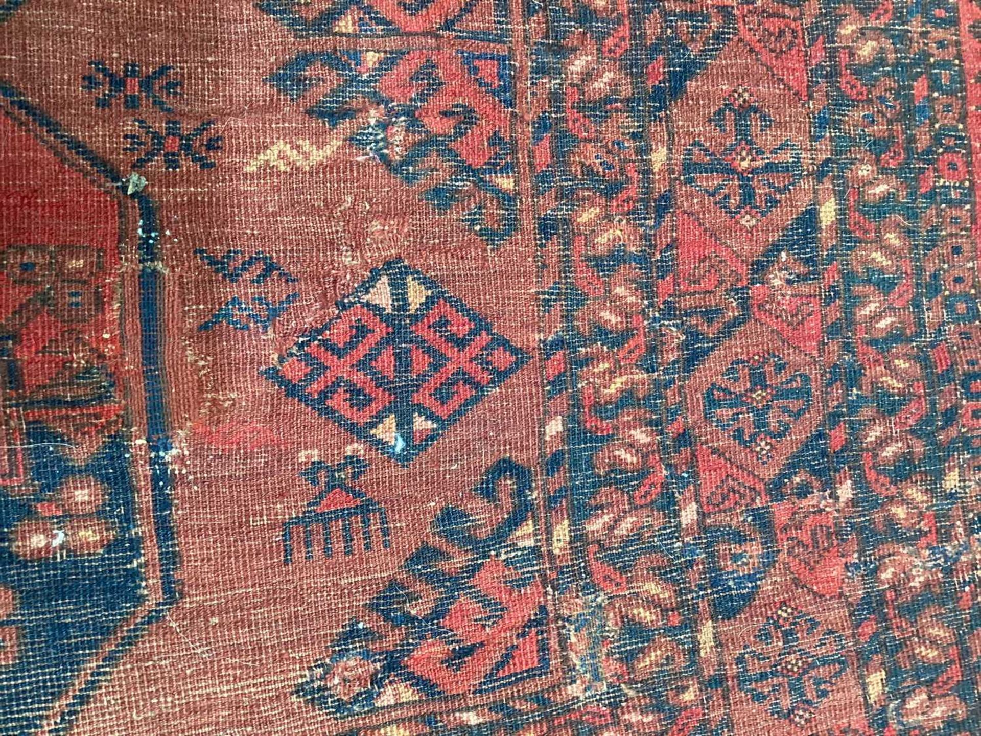 A large antique "Old country house" red ground Afghan carpet, with three rows of elephant foot - Image 26 of 28