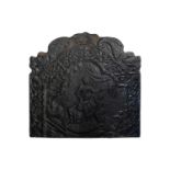 An 18th century style cast iron fire back, the shaped dolphin top over a scrolling frame enclosing