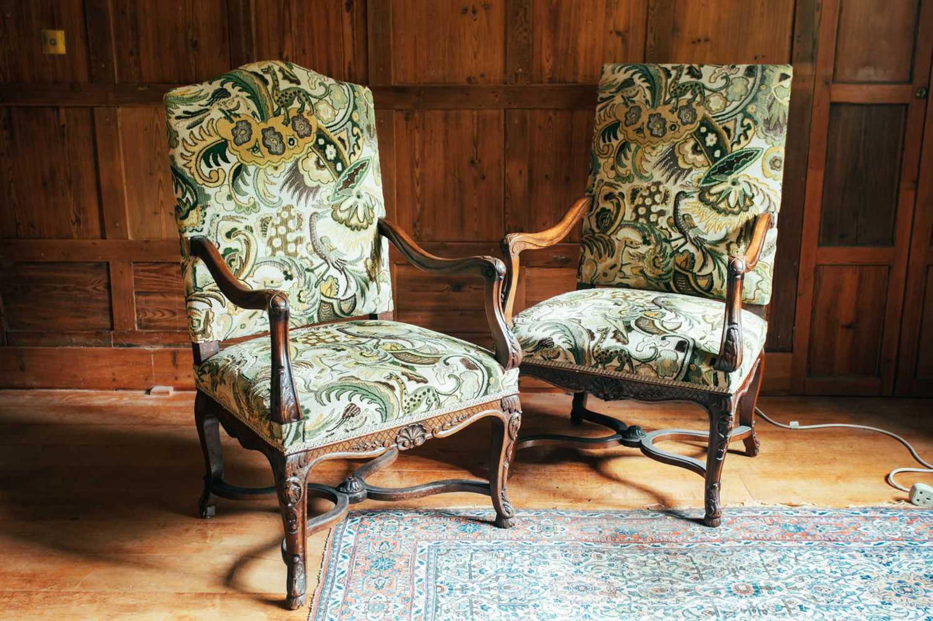 A near pair of 18th-century style French mahogany open armchairs, the upholstered rectangular