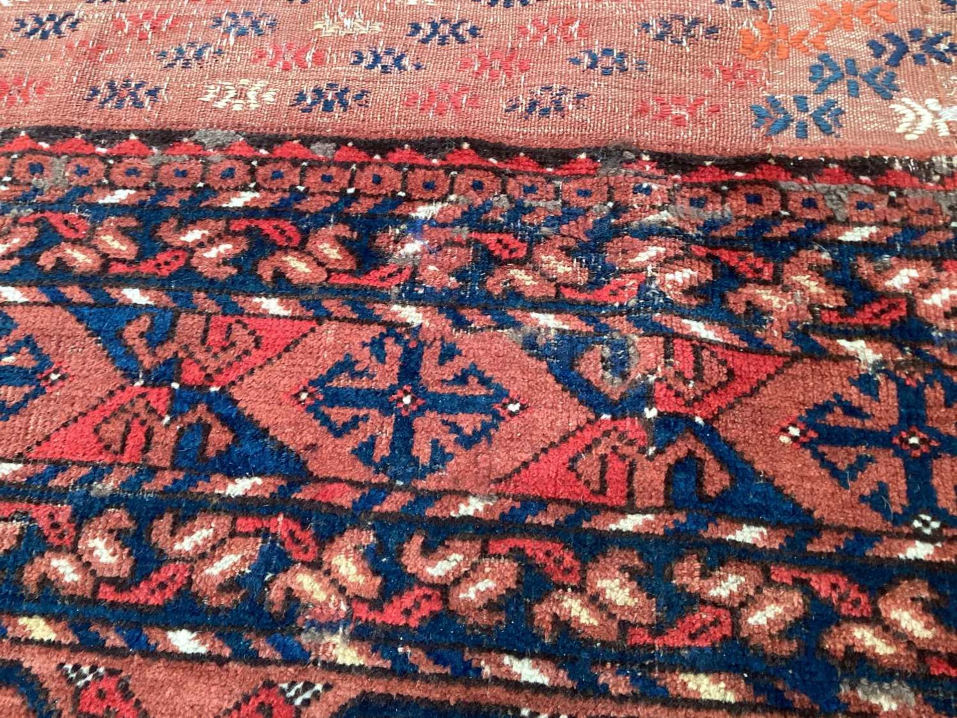 A large antique "Old country house" red ground Afghan carpet, with three rows of elephant foot - Image 13 of 28