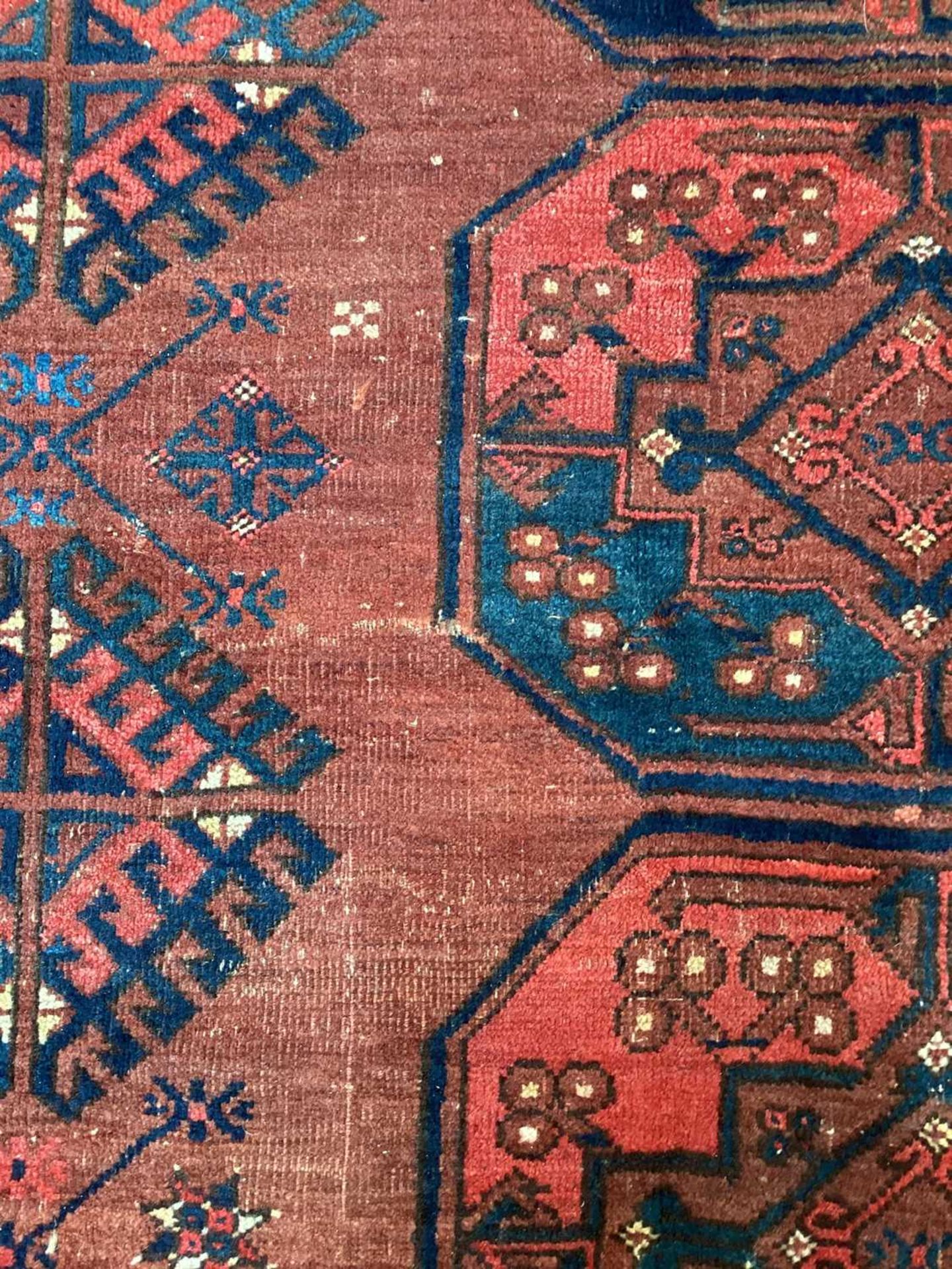 A large antique "Old country house" red ground Afghan carpet, with three rows of elephant foot - Image 18 of 28